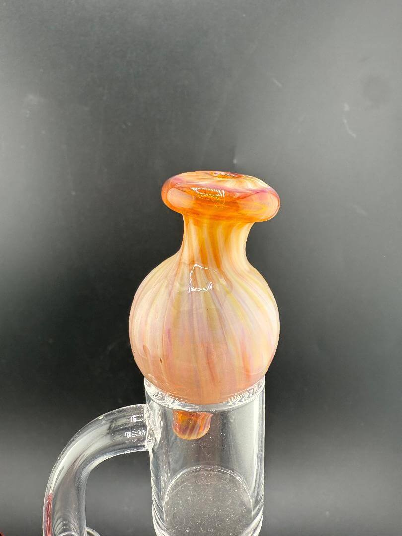 Import Glass Bubble Cap - North Star in amber swirl design, enhancing airflow for quartz bangers.