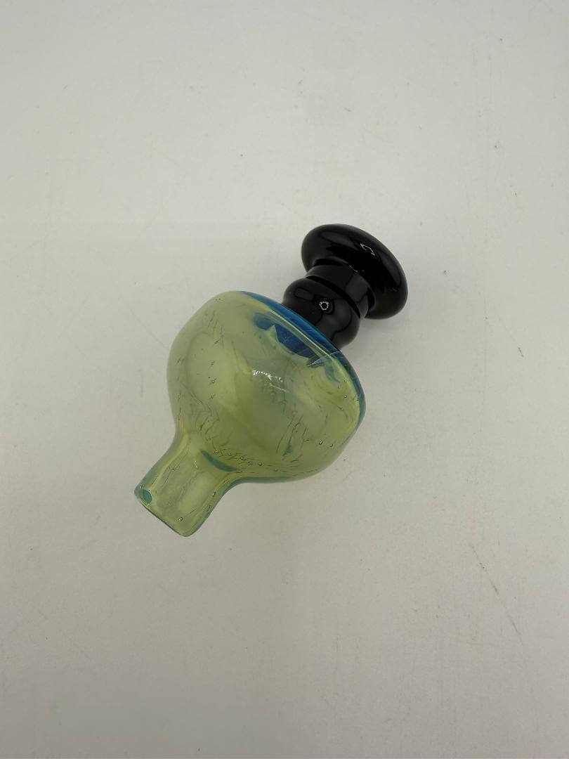 Import Glass Fumed Bubble Cap in green and black, designed for smooth airflow and precise concentrate control.