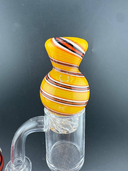Import Glass Spinner Cap - Linework Swirl for 28mm Bangers on a quartz banger, showcasing vibrant swirl design.