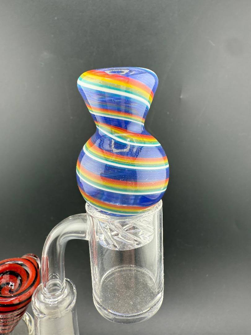 Import Glass Spinner Cap - Linework Swirl for 28mm Bangers on a quartz banger, showcasing vibrant swirl designs.
