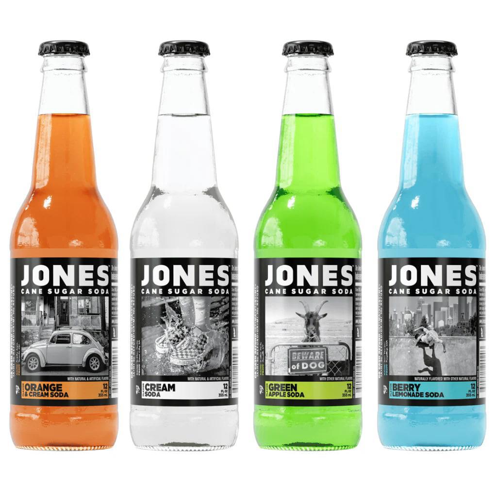 Jones Soda 12oz Bottle assortment featuring Orange, Cream, Green Apple, and Berry flavors in glass bottles.