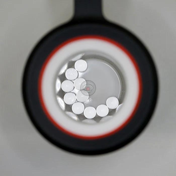 Ruby Pearl Co Terp Pearls – Ruby & Sapphire 3mm AAA Lab-Grown Gemstones (10-Pack) viewed through magnifying lens.