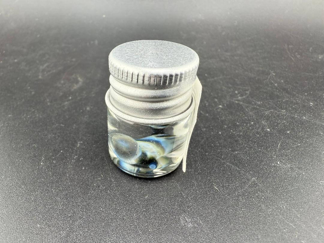 Lucky Gnome Glass Terp Pearl - Boxing glove in a jar with a silver lid, showcasing its unique design and colors.