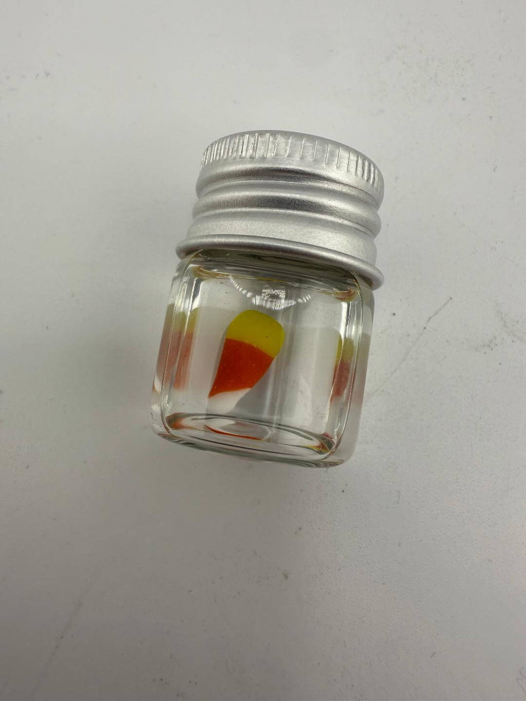 Lucky Gnome Glass Terp Pearl in a clear jar, inspired by candy corn, perfect for enhancing dab sessions.