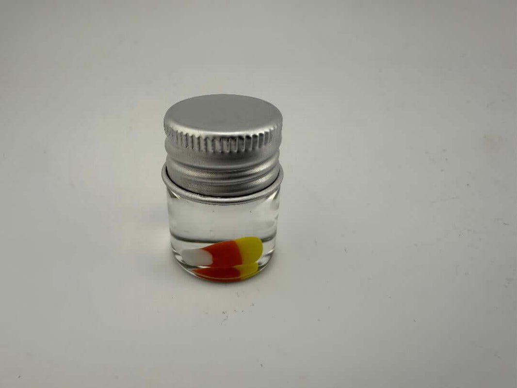 Lucky Gnome Glass Terp Pearl - Candy Corn in a clear container with a silver cap, perfect for enhancing dabbing sessions.
