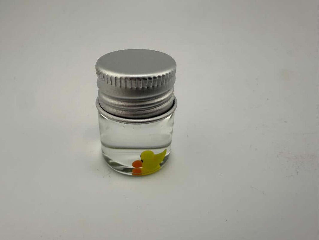 Lucky Gnome Glass Terp Pearl - Ducky in a clear jar with a silver lid, perfect for dab setups.