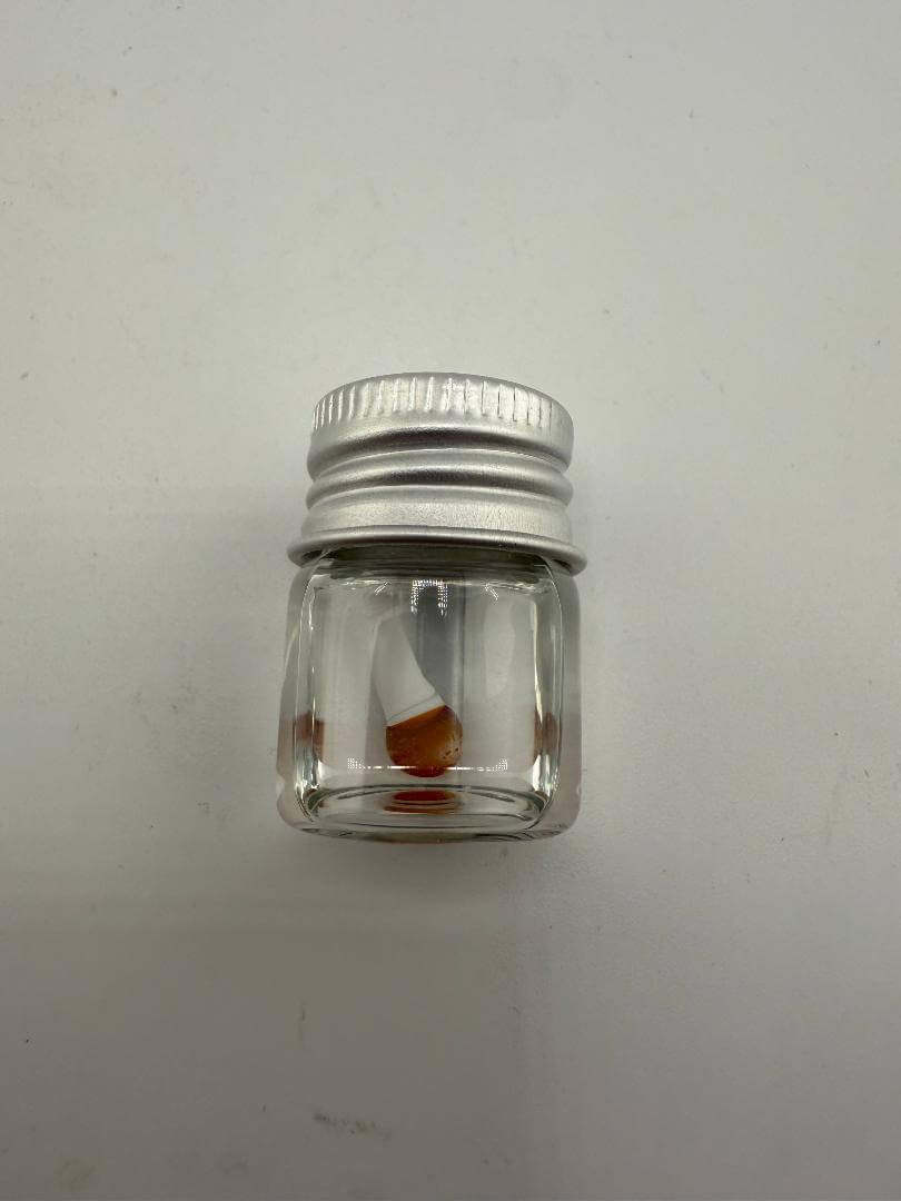 Lucky Gnome Glass Terp Pearl in a clear jar with a silver lid, showcasing unique mushroom design.