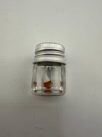 Lucky Gnome Glass Terp Pearl in a clear jar with a silver lid, showcasing unique mushroom design.