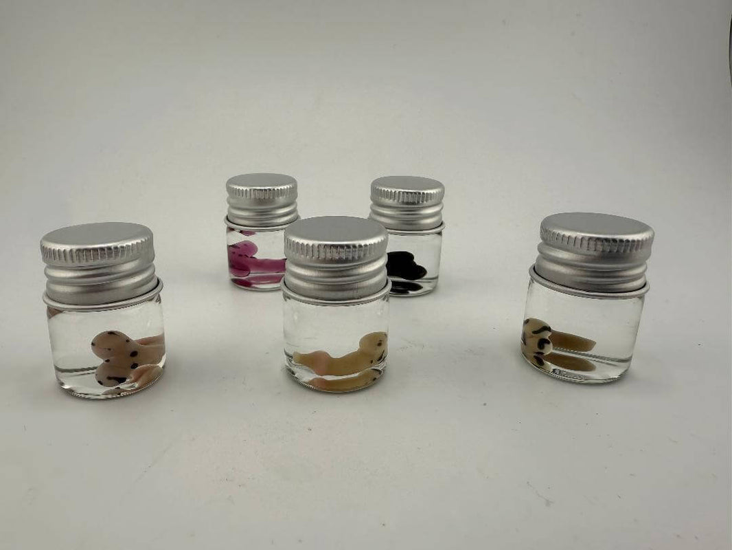 Lucky Gnome Glass Terp Pearls in jars with playful designs for dab accessories.