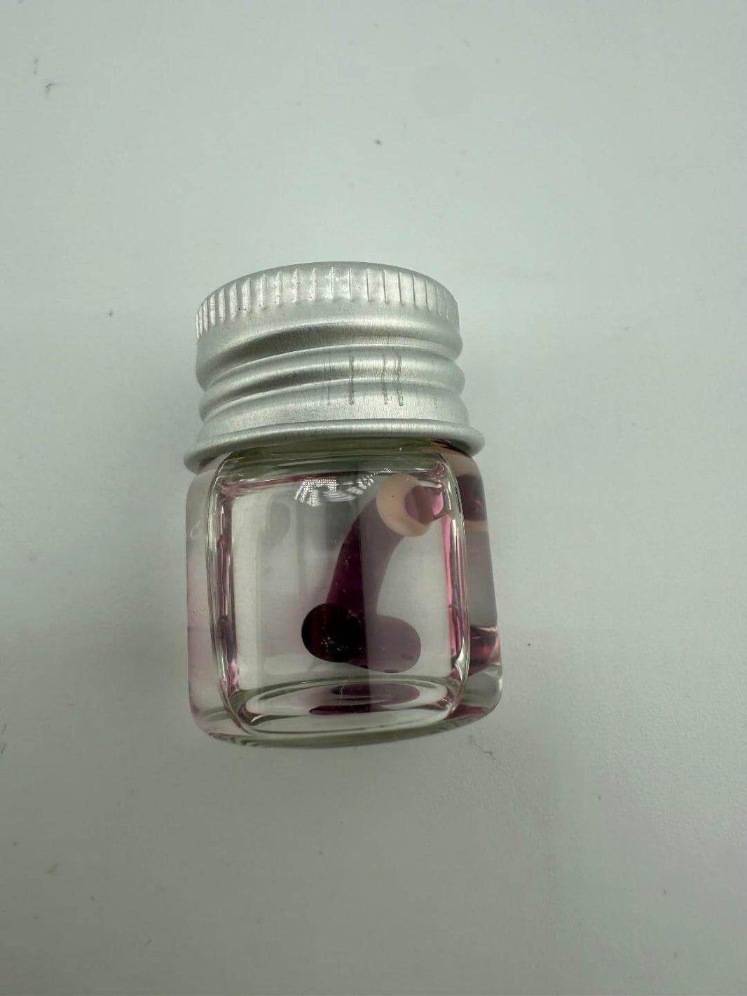 Lucky Gnome Glass Terp Pearl in a glass jar with silver lid, showcasing a playful novelty design for dab rigs.