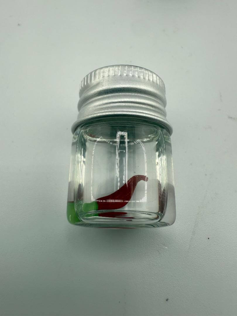 Lucky Gnome Glass Terp Pearl in a jar with a vibrant red and green pepper design for enhanced dab sessions.