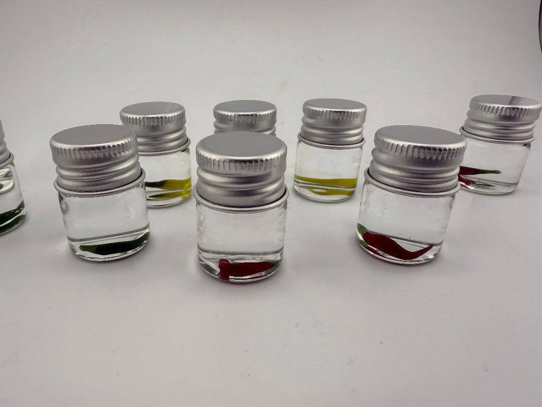 Multiple Lucky Gnome Glass Terp Pearls in jars featuring red, yellow, and green peppers for enhancing dab sessions.