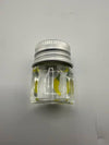 Clear glass jar with a silver lid, containing yellow banana-shaped terp pearl for dabbing accessories.