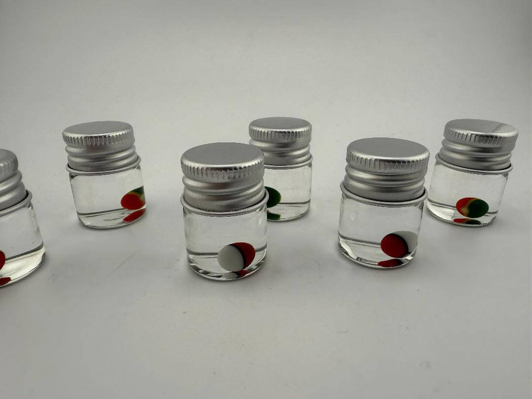 Lucky Gnome Glass Terp Pearl Pokeball in clear jars, colorful pearls for enhancing dabbing experience.