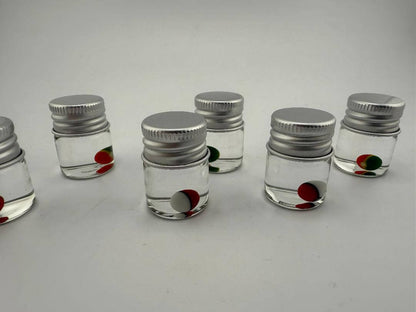 Lucky Gnome Glass Terp Pearl Pokeball in clear jars, colorful pearls for enhancing dabbing experience.