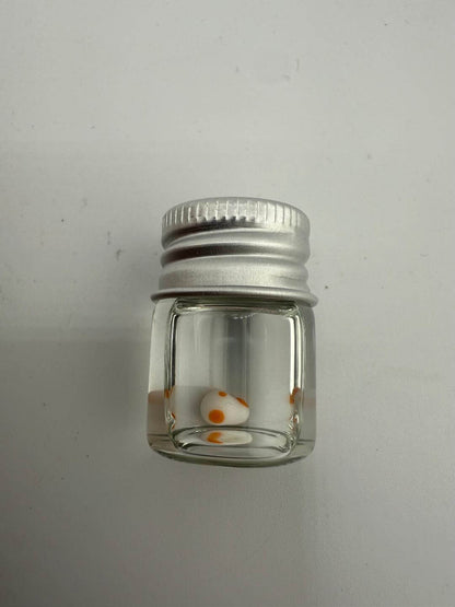 Lucky Gnome Glass Terp Pearl in jar, featuring playful Yoshi Egg design with orange spots.