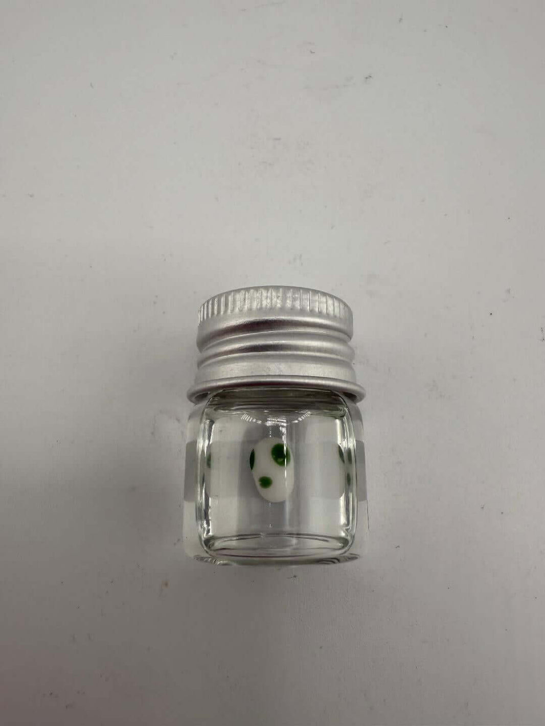 Lucky Gnome Glass Terp Pearl - Yoshi Egg in clear jar with green dots, ideal for enhancing dab sessions.