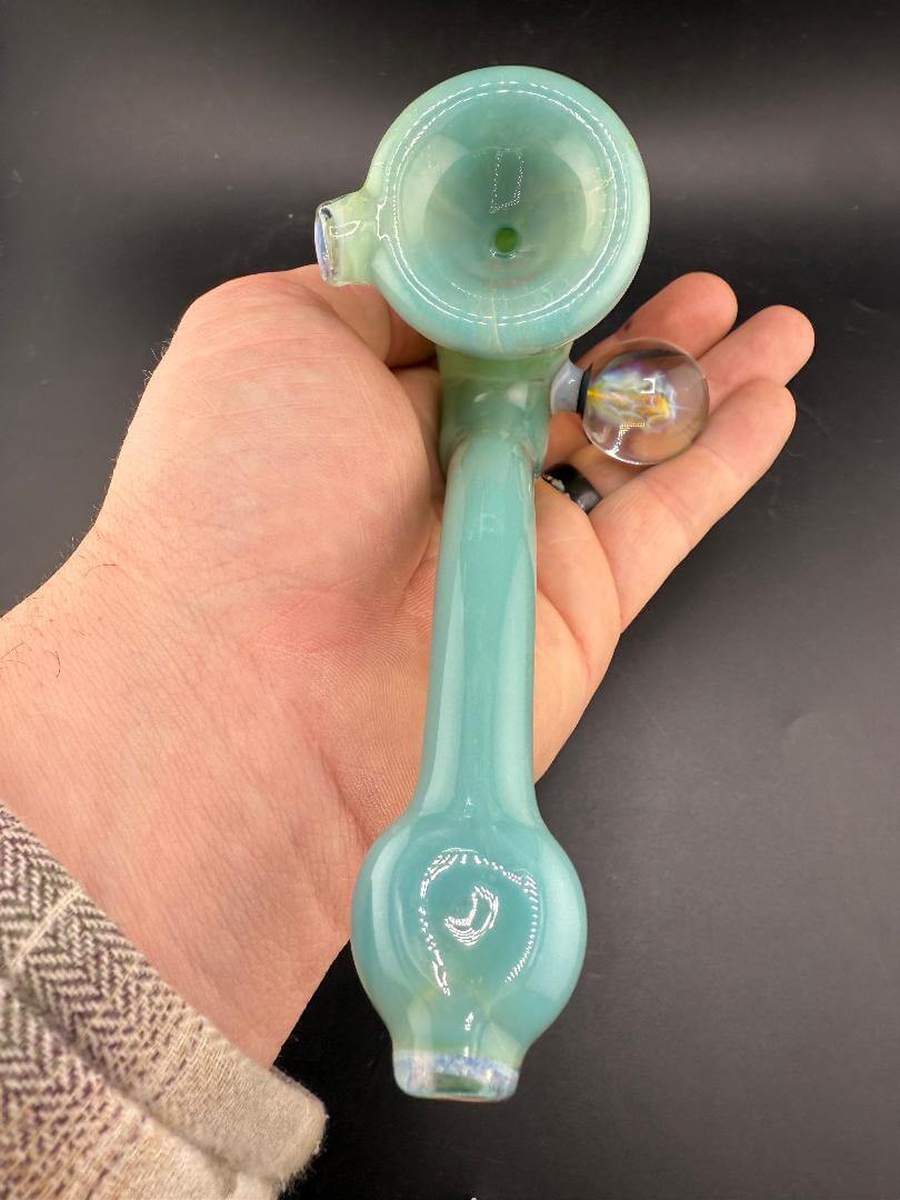 Mank Glass Sherlock Pipe - Green & Orange w/ Implosion Marble Attachment held in hand, showcasing its vibrant colors and design.