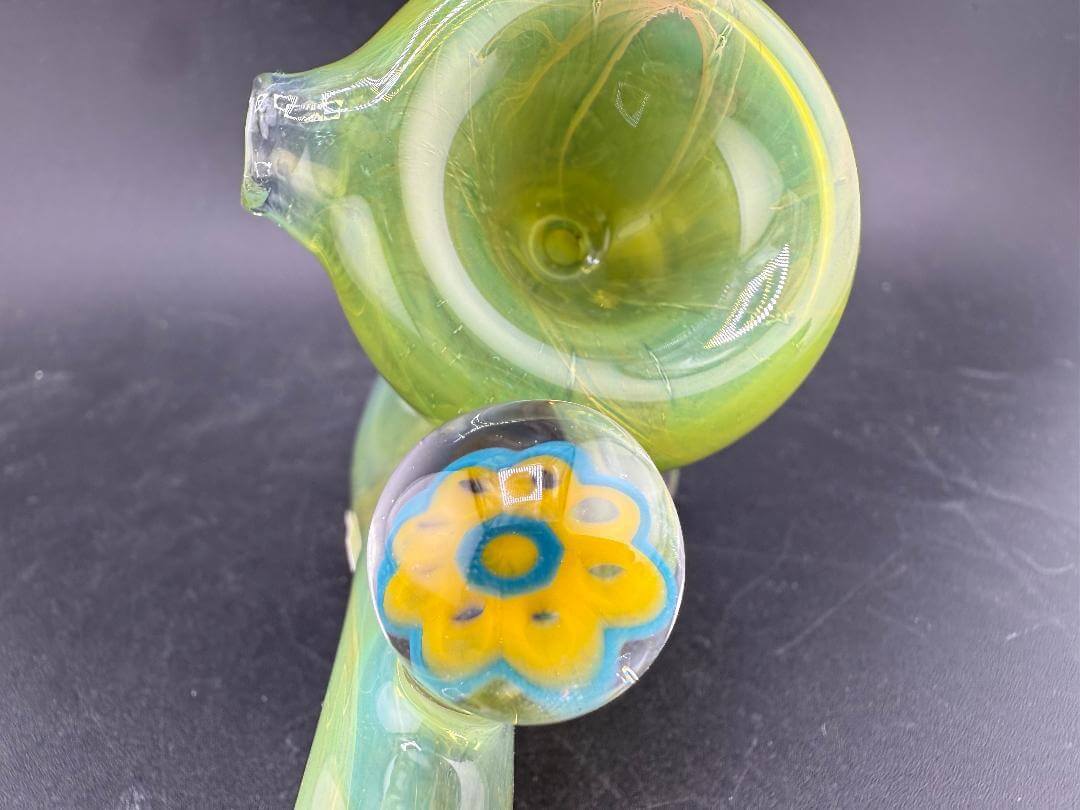 Mank Glass Sherlock Pipe - Green w/ Skull Millie featuring a vibrant design and unique flower detail.