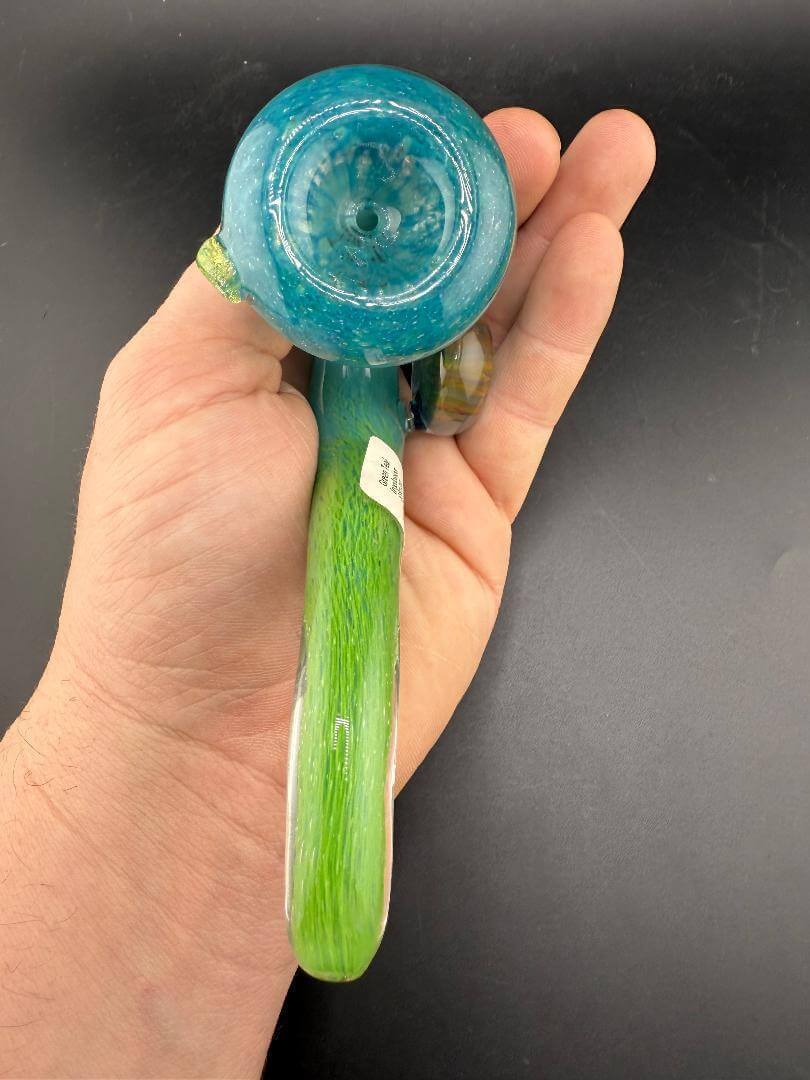 Mank Glass Sherlock Pipe - Green & Teal w/ Implosion Marble Attachment held in hand, showcasing its vibrant colors and design.