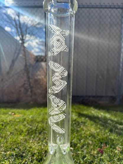 MAV Glass 18' Beaker 14mm 45° - Glow In The Dark Tribal design showcasing intricate patterns on a clear glass surface.