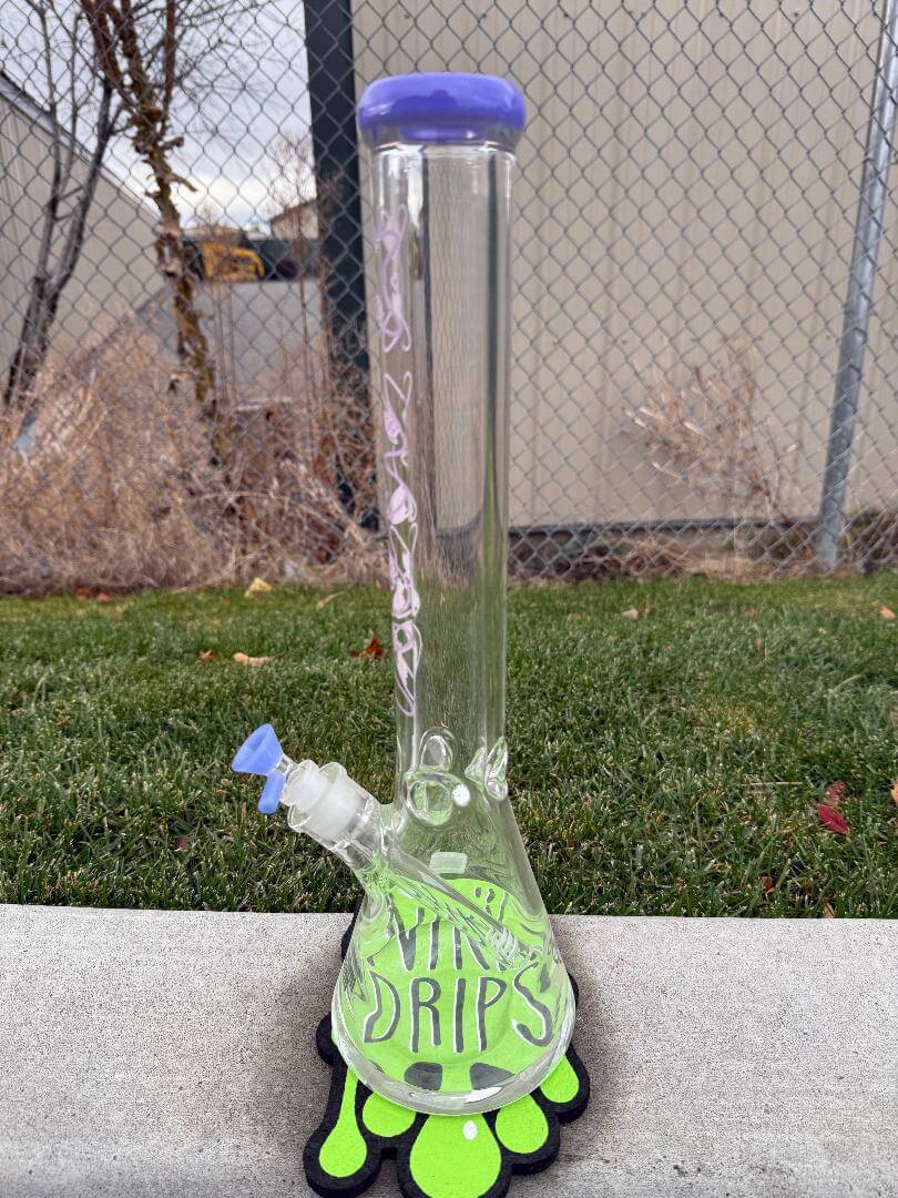 MAV Glass 9mm Thick 18" Beaker - Purple Lotus standing on grass, showcasing elegant design and functionality.