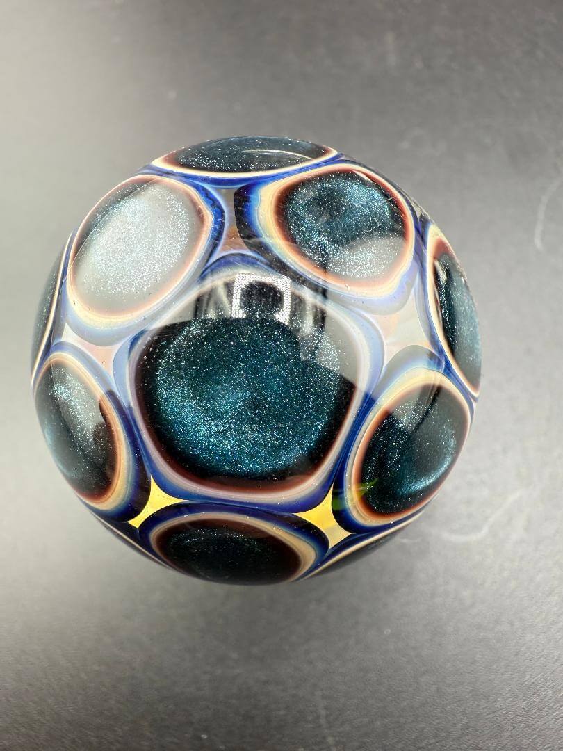 McDoogIe Glass Marble – 34mm Gold Fume Implosion showcasing vibrant color and intricate design.