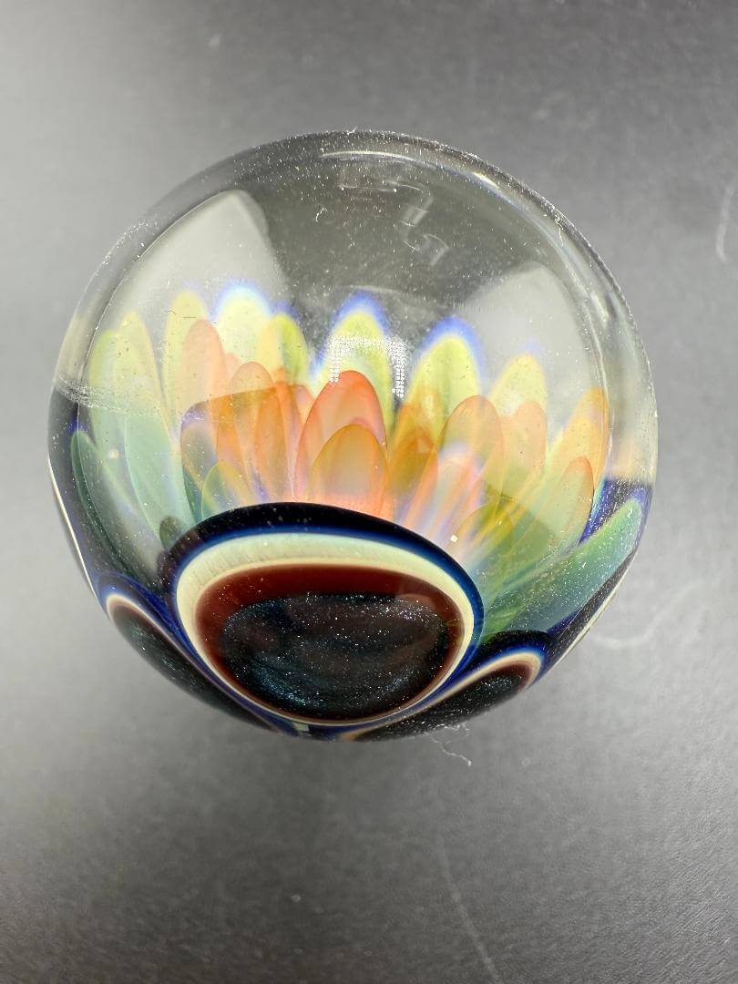 McDoogIe Glass Marble – 34mm Gold Fume Implosion showcasing vibrant color shifts and artistic craftsmanship.
