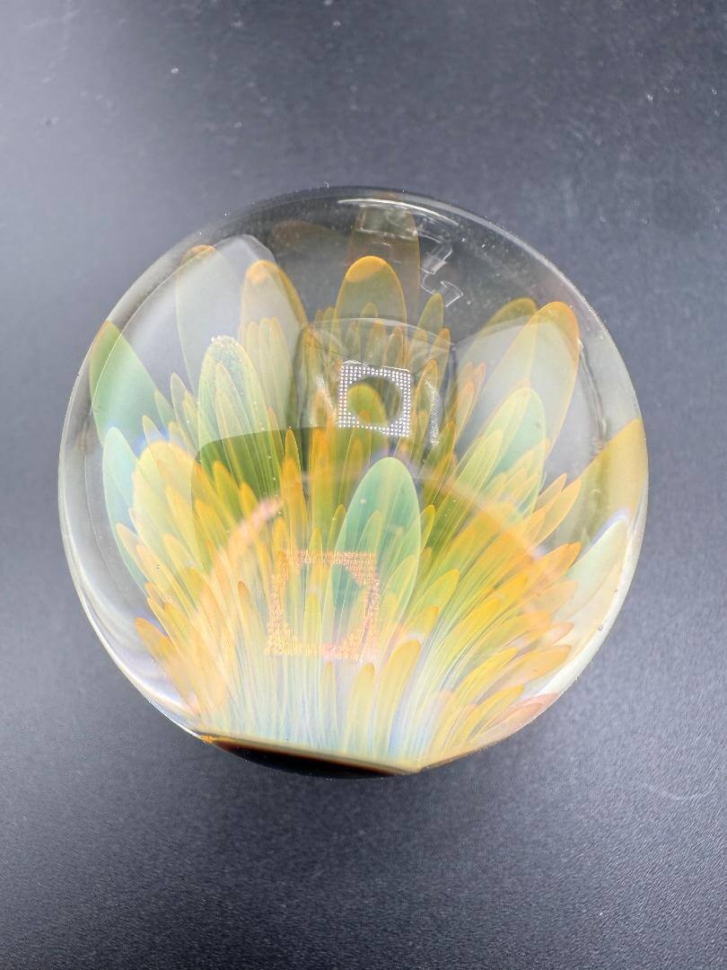 McDoogIe Glass Marble – 39mm Gold Fume Implosion showcasing vibrant color shifts and artistic implosion pattern.