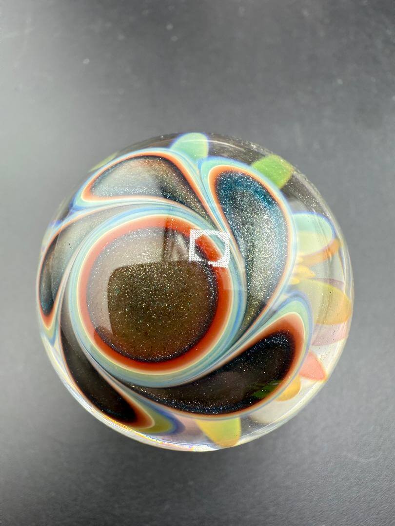 McDoogIe Glass Marble – 39mm Gold Fume Implosion showcasing vibrant colors and deep implosion pattern.