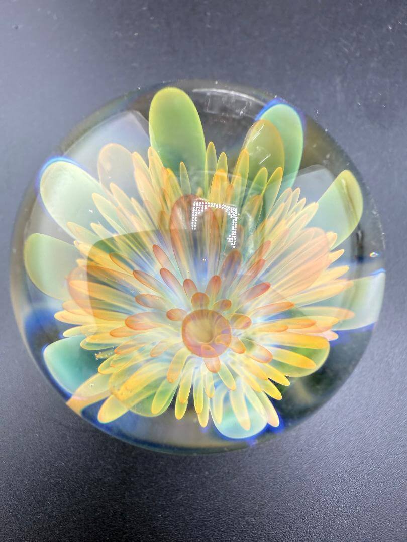McDoogIe Glass Marble – 39mm Gold Fume Implosion showcasing vibrant colors and intricate implosion pattern.