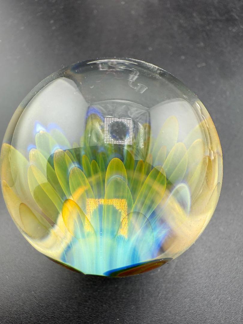 McDoogIe Glass Marble – 40mm Gold Fume Implosion showcasing vibrant colors and depth in a glass marble.