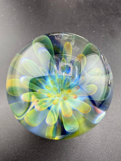 McDoogIe Glass Marble – 40mm Gold Fume Implosion showcasing vibrant colors and detailed craftsmanship.