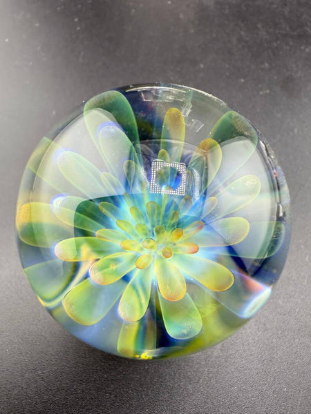 McDoogIe Glass Marble – 40mm Gold Fume Implosion showcasing vibrant colors and detailed craftsmanship.