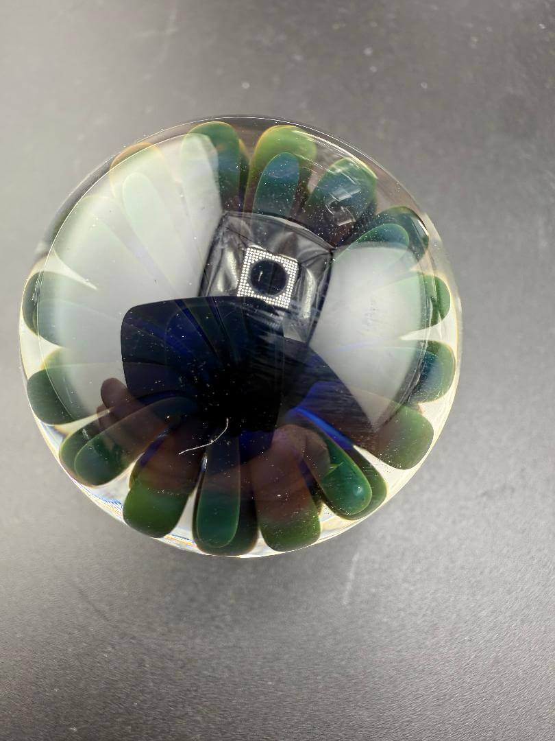 McDoogIe Glass Marble – 40mm Gold Fume Implosion showcasing vibrant color shifts and swirling patterns.