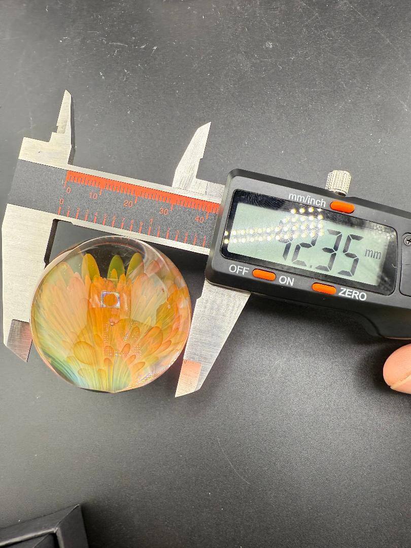 McDoogIe Glass Marble – 42mm Gold Fume Implosion measured for size accuracy.