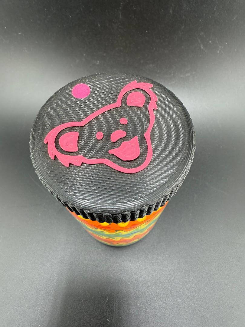 Top view of McDoogle Glass Baller Jar with Grateful Dead bear lid in vibrant colors, ideal for stylish storage.