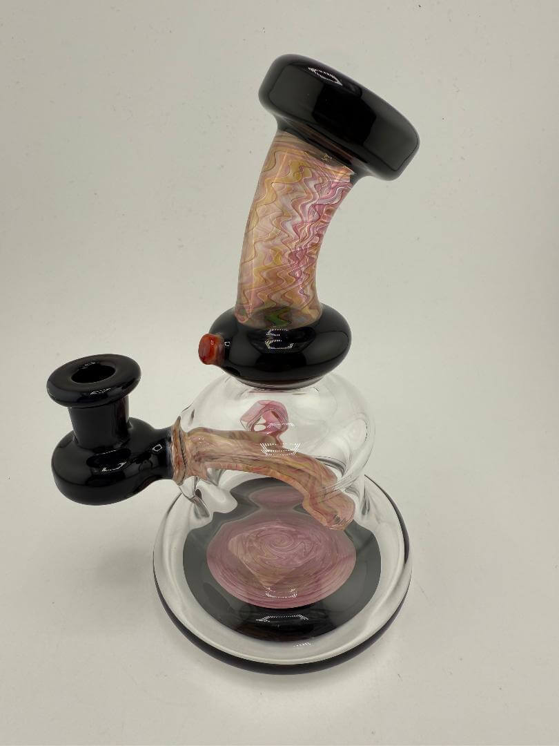 Mcdoogle Glass Fumed Banger Hanger 10mm Rig with colorful handle and black base, showcasing evolving color and handblown design.