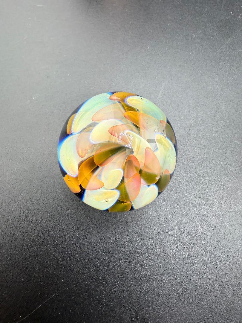 Mcdoogle Glass Marble - 31mm Fume Implosion showcases vibrant colors and intricate depth in a handcrafted design.