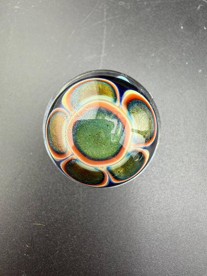 Mcdoogle Glass Marble - 31mm Fume Implosion view from above, showcasing vibrant colors and intricate design.