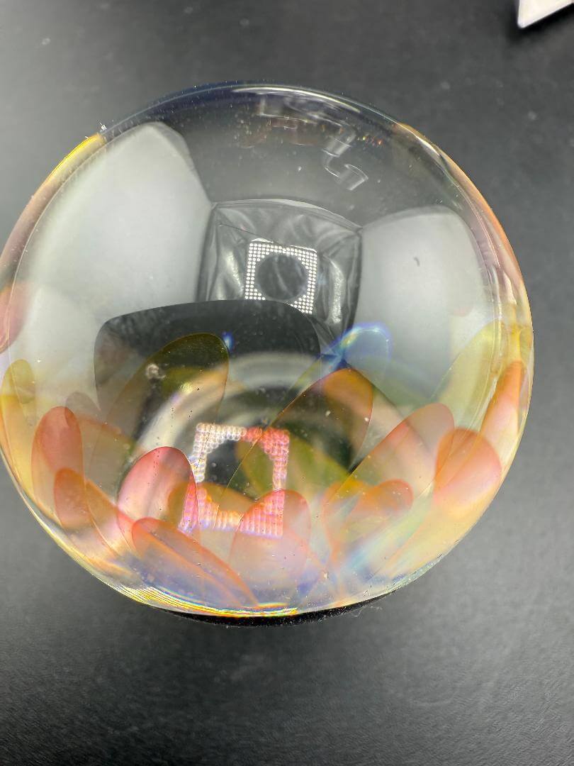 McDoogle Glass Marble – 40mm Gold Fume Implosion showcasing vibrant colors and deep internal implosion details.