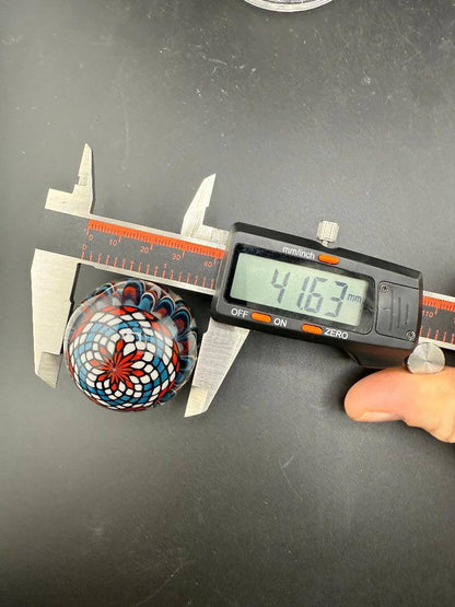 Mcdoogle Glass Marble - 41mm Red White & Blue Implosion & Fillacello being measured with calipers.