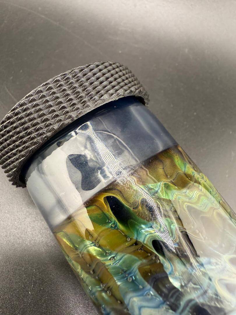 McDoogle Glass Nug Jar with colorful Seed of Life design and textured black lid, handcrafted borosilicate jar.