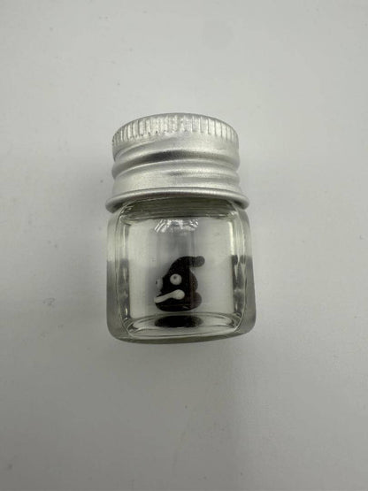 Lucky Gnome Glass Terp Pearl in a clear glass jar with a silver lid, featuring a playful poop emoji design.