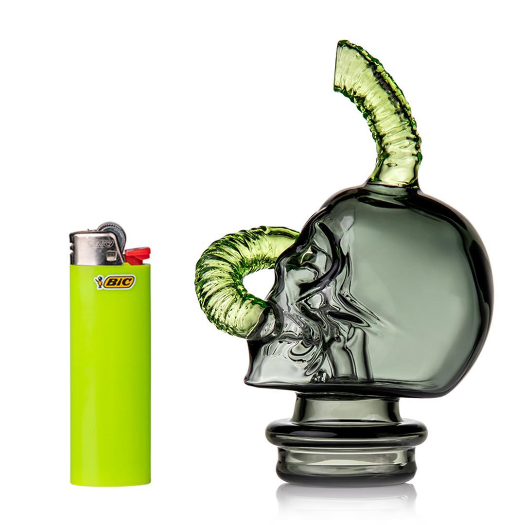 MJ Arsenal Grim Ripper Puffco Peak Top- Skull & Worm next to a green Bic lighter for scale