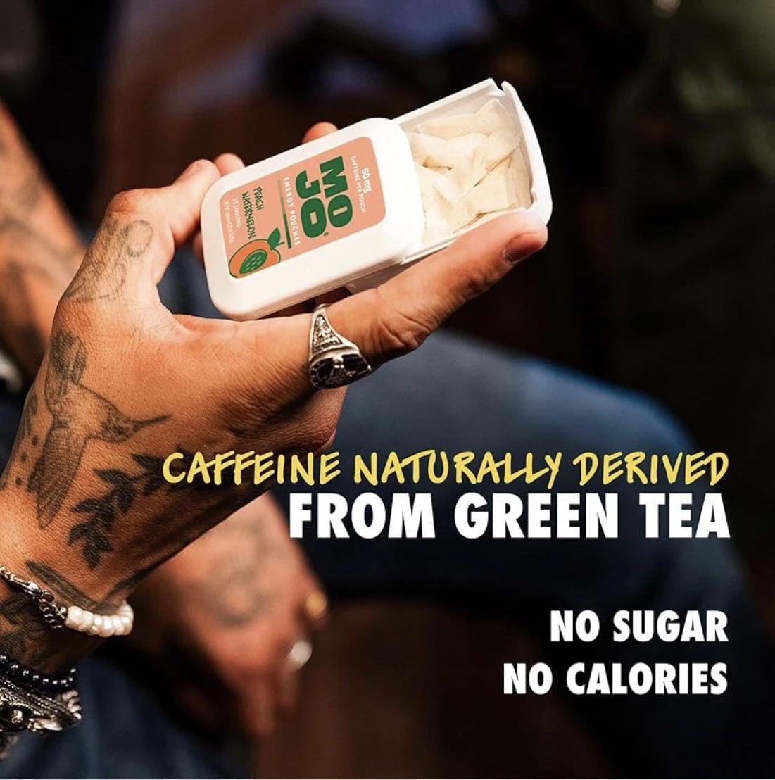 Hand holding MOJO Energy Pouches, showcasing caffeine naturally derived from green tea, no sugar, no calories.