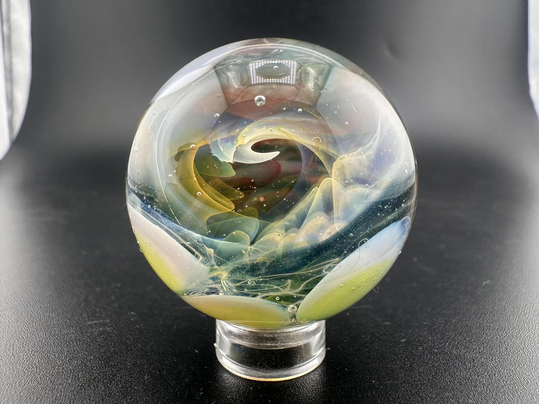 Mop Head Glass Marble - Fumed Implosion Swirl featuring vibrant color trails and mesmerizing swirl design.