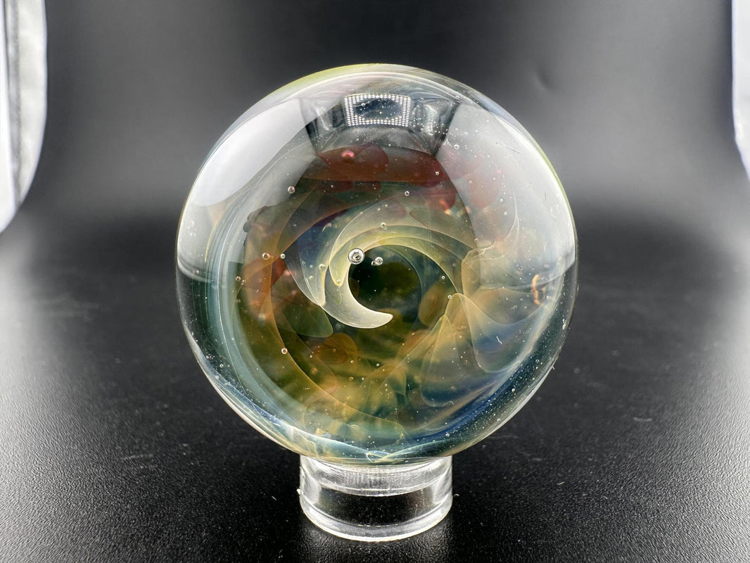 Mop Head Glass Marble - Fumed Implosion Swirl featuring vibrant color trails and mesmerizing implosion design.