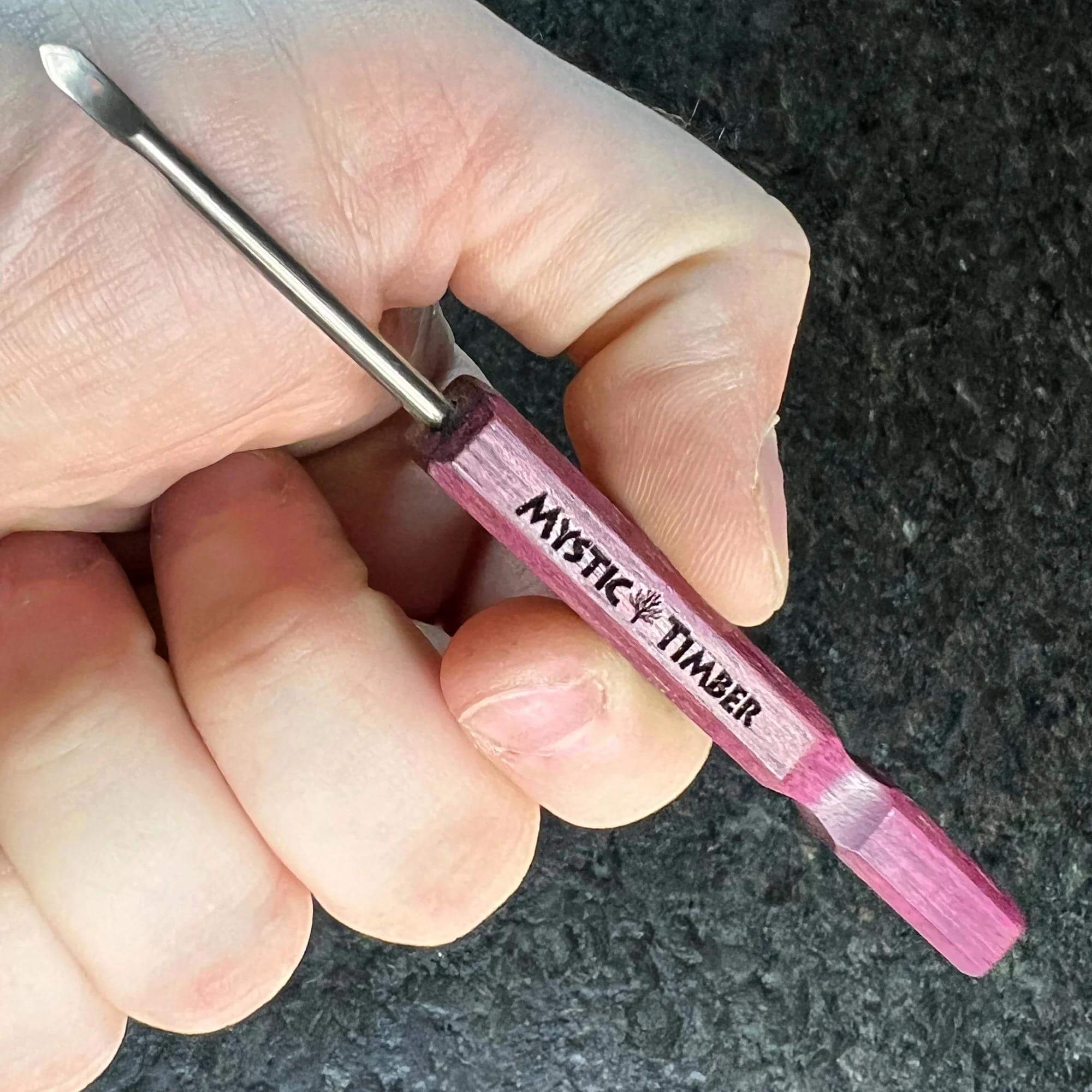 Mystic Timber Dab Tool - Long Handled Pick held in hand, featuring a G2 titanium tip and premium hardwood handle.