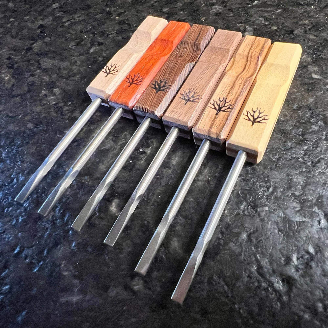 Mystic Timber Dab Tool - Pocket Flat Shovel set with various hardwood handles and titanium tips on a black surface.